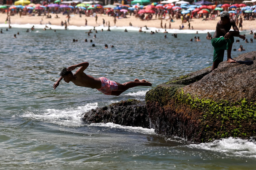 RIO DE JANEIRO, BRAZIL - JANUARY 27: A person dives into the water at Copacabana beach 2on January 27, 2023 in Rio de Janeiro, Brazil. (Photo by Buda Mendes/Getty Images)