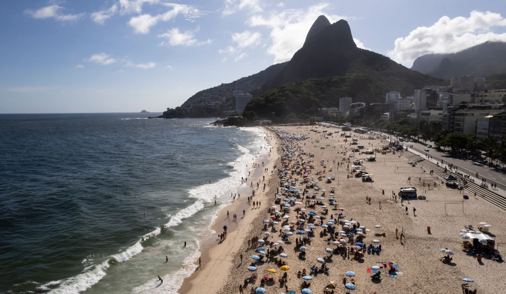 RIO DE JANEIRO, BRAZIL - JANUARY 26: : In an aerial view, tourists and locals enjoy the sunset during the summer at famous Ipanema beach on January 26, 2023 in Rio de Janeiro, Brazil.
