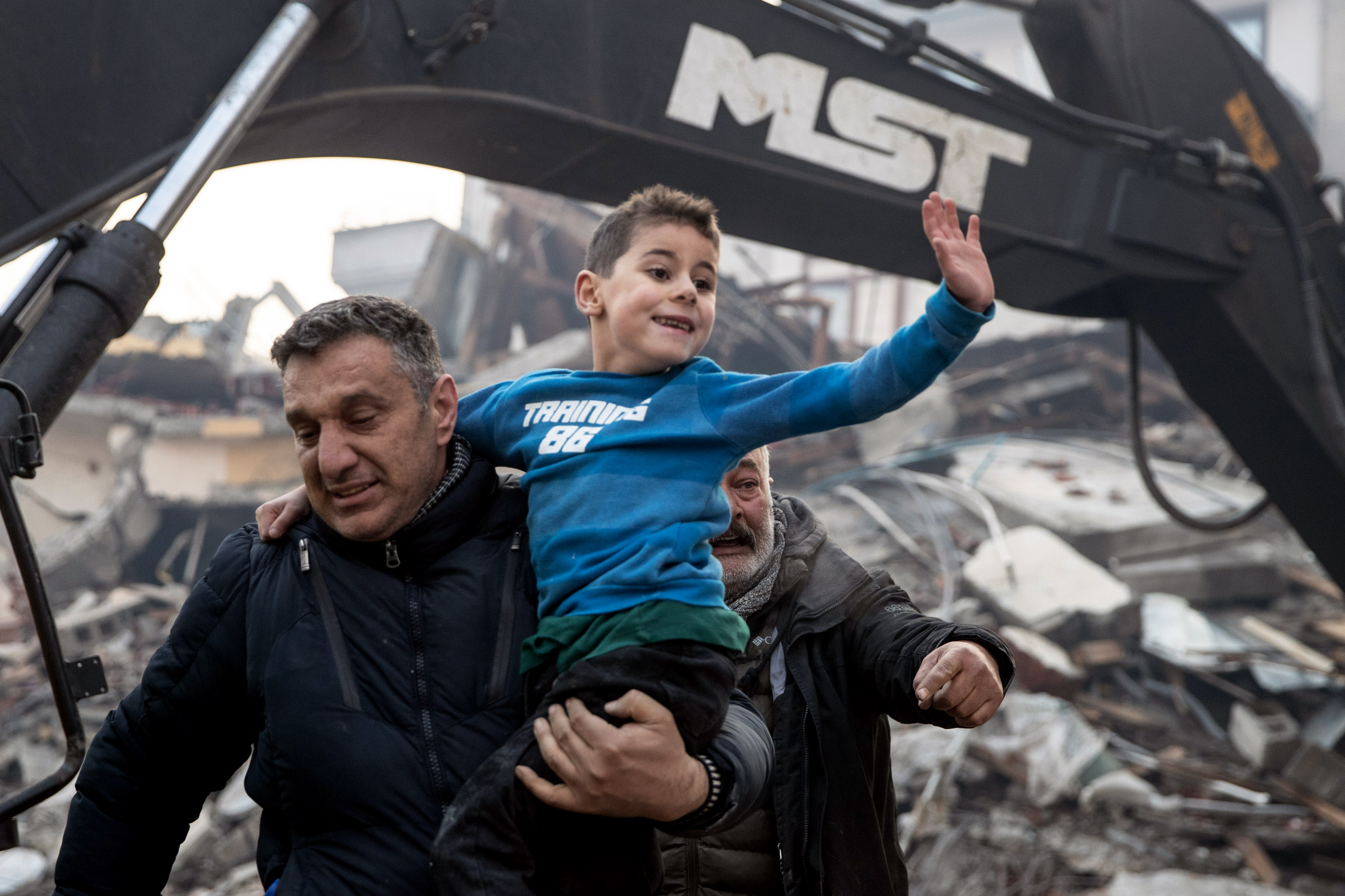 HATAY, TURKEY - FEBRUARY 08: Rescue workers carry 8-year-old survivor Yigit at the site of a collapsed building 52 hours after an earthquake struck on February 08, 2023 in Hatay, Turkey. A 7.8-magnitude earthquake hit near Gaziantep, Turkey early Monday, followed by another 7.5-magnitude tremor just after midday. The quakes caused widespread destruction in southern Turkey and northern Syria and were felt in nearby countries. (Photo by Burak Kara/Getty Images)