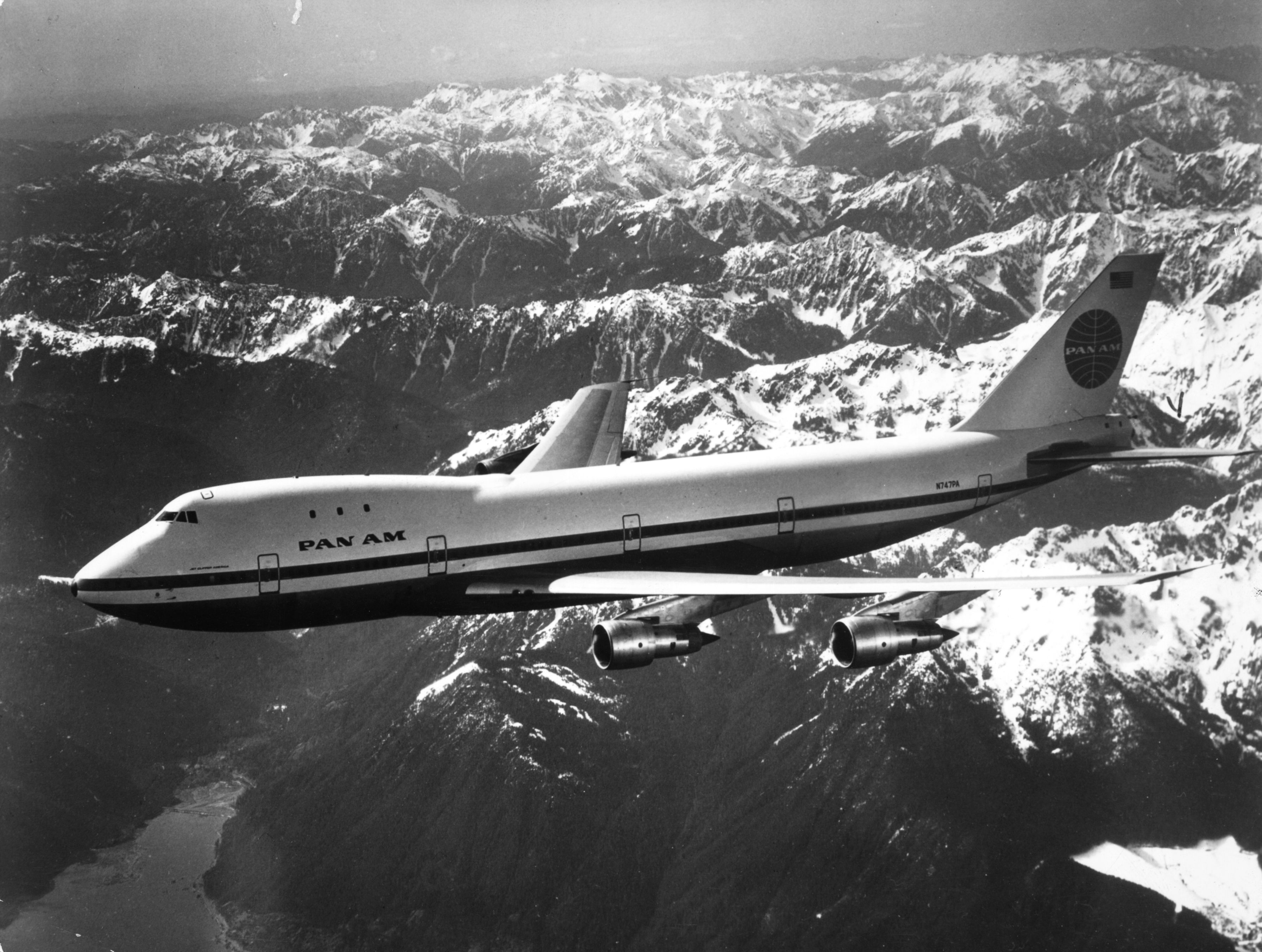 A Pan Am boeing 747 flying over snow covered mountains. Image: Keystone / Getty Images