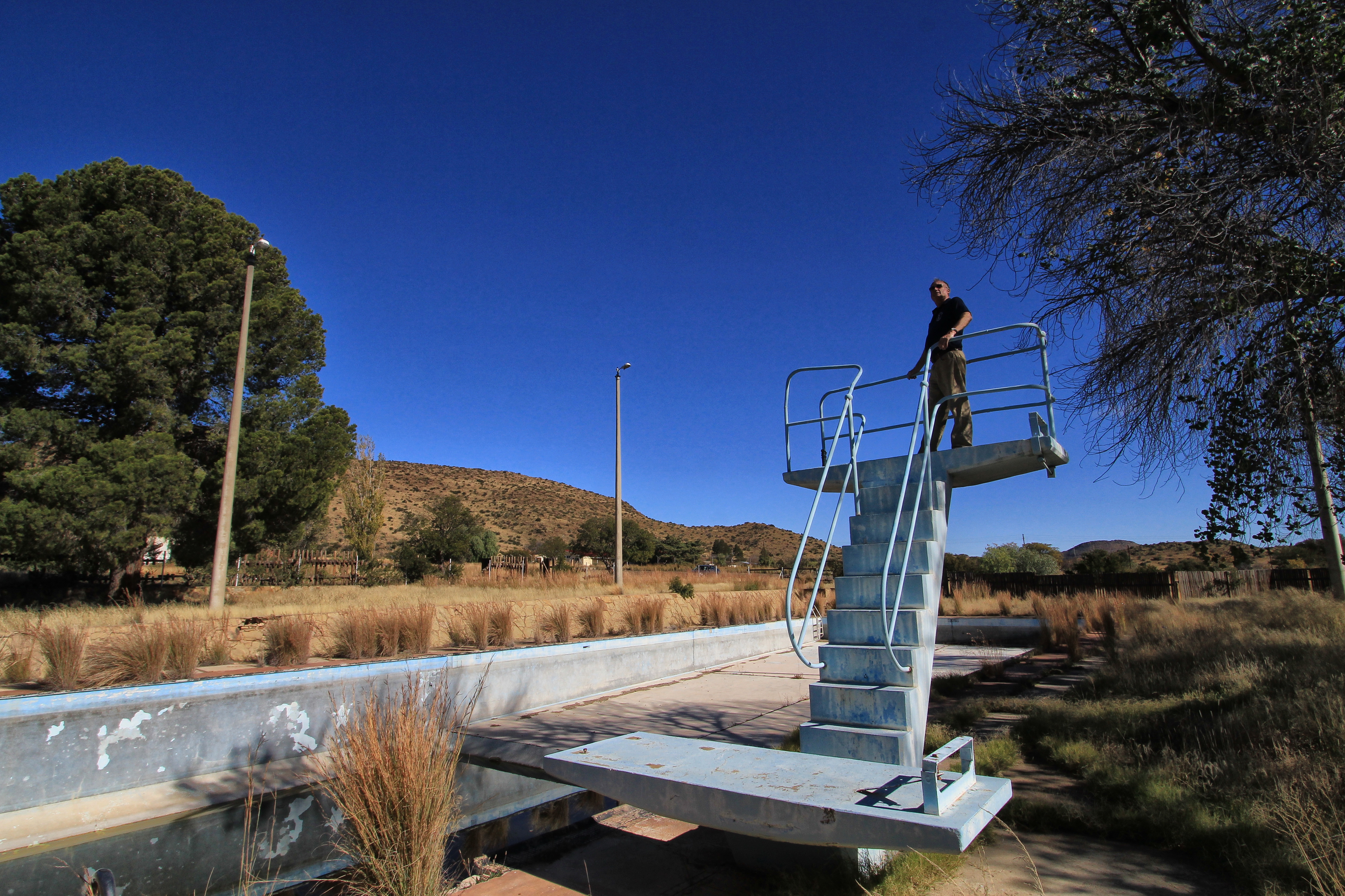 Stephen Mullineux, now retired from the Department of Water Affairs, stands on the old diving board at abandoned Teebus. Image: Chris Marais