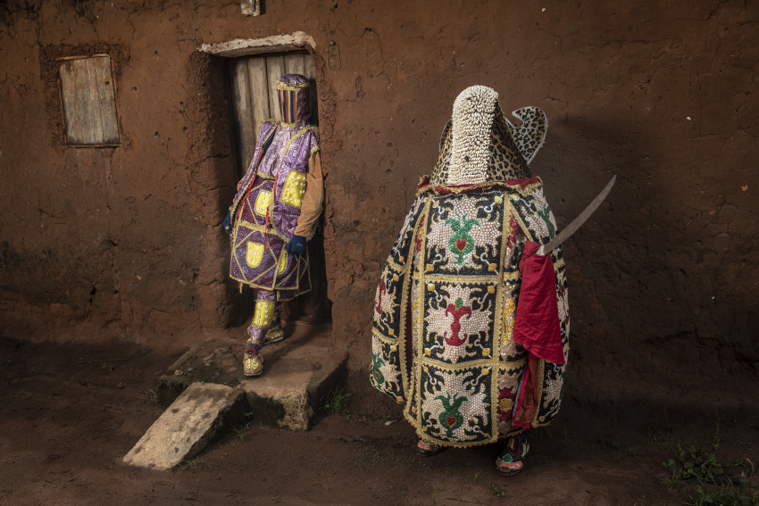 Two ‘ghosts’ pose in front of their ancestors’ house. Porto-Novo, Benin. The Egungun association is a secret voodoo society that honours the spirits of their ancestors and perpetuates their memories. These ancestral spirits are believed to be in constant watch over their living relatives; they bless, protect and warn them, but can also punish them depending on whether they remember or neglect them. The spirits can also protect a community against evil spirits, epidemics, witchcraft and evil doers, ensuring their well-being, and may even be invited to come to earth physically. When they do, the Egungun are the receptacles of these spirits, appearing in the streets day or night, leaping, dancing or walking, and uttering loud cries. The spirit is supposed to have returned from the land of the dead to ascertain what is going on, so can be considered a kind of supernatural inquisitor who appears from time to time to inquire into the general domestic conduct of people and punish misdeeds. © Jean-Claude Moschetti, France, Finalist, Professional competition, Portraiture, Sony World Photography Awards 2023