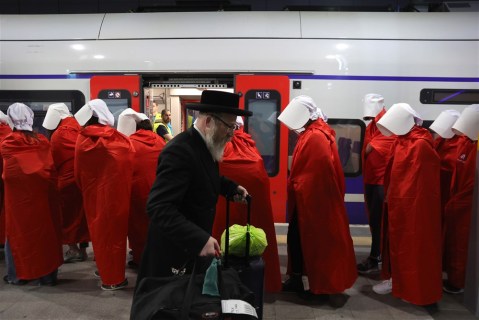 In images: Women in ‘Handmaid’s Tale’ costume ride a train during an anti-government protest in Jerusalem