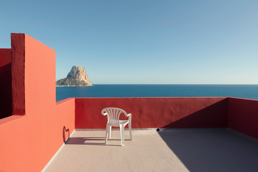 "Muralla Roja". After a few hours of shooting, it felt like this was the best spot to take a break, so I found a chair and brought it over. The moment I placed the chair I knew this would be a great photograph. Sadly, Ricardo Bofill passed away just a few weeks after I made this image, and so this empty chair acquired a lot of symbolism. Designed by Ricardo Bofill, the Muralla Roja apartment complex is one of the most iconic pieces of Spanish architecture. Over the years I have revisited this place to photograph it again and again. On my last visit, in December 2021, my goal was to create a totally different series by capturing the Muralla Roja during the day, at sunset, at night and at sunrise. I started shooting very early in the morning and continued well into the night. I then woke early to experience an unforgettable sunrise. Sadly, Bofill passed away just a few weeks after my visit, so I consider this series to be a personal tribute to him and his legacy. © Andres Gallardo Albajar, Spain, Finalist, Professional competition, Architecture & Design, Sony World Photography Awards 2023