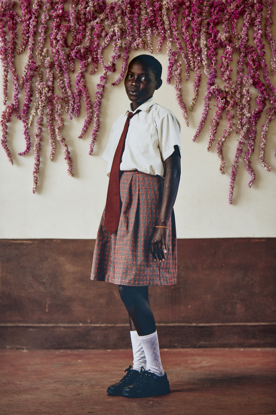 "Michealle Naeku". Portrait of 12-year-old Michealle Naeku, a student at Kakenya’s Dream school in Enoosaen, Kenya. Naeku is an avid reader and dreams of becoming a nurse. The flowers are used to create a playful world where girls are shown exuding pride and joy. In this way the flowers are also used to reclaim their futures and dreams, and to re-imagine the narrative of child marriage. What do girls dream of? And what happens when a supportive environment is created where girls are empowered and given the opportunity to learn and dream? The Right to Play creates a playful world where girls are shown in an empowered and affirming way. Worldwide, it is estimated that around 129 million girls are out of school and only 49 percent of countries have achieved gender parity in primary education, with the gap widening at secondary school level. Every day, girls face barriers to education caused by poverty, cultural norms and practices such as FGM, poor infrastructure and violence. For this project, I worked with girls from Kakenya’s Dream in Enoosaen, Kenya who have avoided FGM and child marriage, showing what the world can look like when girls are given the opportunity to continue learning in an environment that supports them and their dreams. © Lee-Ann Olwage, South Africa, Finalist, Professional competition, Creative, Sony World Photography Awards 2023