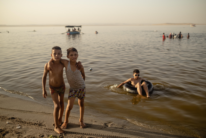 "The Lost Lake 8". Two children pause for a photograph at Lake Qarun. In summer, many people come from Fayoum, Beni Suef and Giza to bathe in the lake, but most are unaware of the dangers caused by untreated sewage, agricultural wastewater and industrial waste. Lake Qarun, located in the Fayoum in south west Egypt, is one of the oldest lakes in the world, containing fossils that are millions of years old. During the Pharaonic era, flooding meant that this low-lying lake was supplied with freshwater from the Nile, but since the start of the 20th Century it has grown increasingly saline. Various fish species have already disappeared due to increased pollution and changes to the climate, and the health of Lake Qarun and the wildlife within it are now seriously endangered by its rising saline level, which is higher than that of seawater. To compound this, a parasitic infection has spread throughout the lake, which has negatively impacted fish production and quality, thereby harming the fishing community in Fayoum: the number of fishing boats operating in the lake has decreased from 605 to just 10 boats. This project attempts to explore the lives of the fishermen residing in the village of Ezbat Soliman, near Lake Qarun, and how the lake’s pollution affects them. © Fatma Fahmy, Egypt, Shortlist, Professional competition, Environment, Sony World Photography Awards 2023