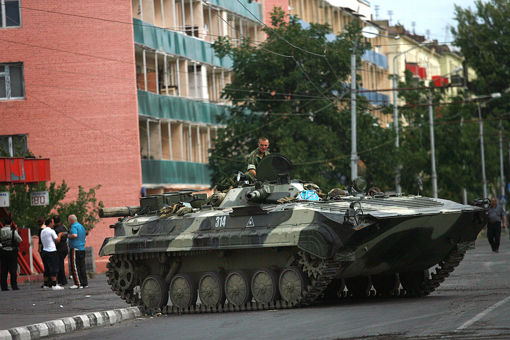 A Russian soldier sits on a tank at a checkpoint on August 14, 2008 in Gori, Georgia. Russia have started to hand over regional control around the city of Gori to Georgian forces. (Photo by Uriel Sinai/Getty Images)