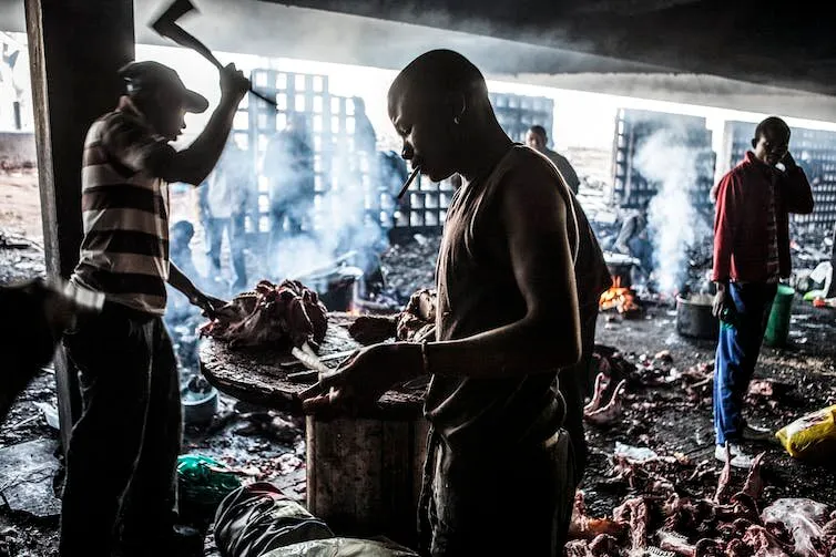 Chopping cowheads in Kazerne parking garage, from 'Wake Up, This Is Joburg'. Image: Mark Lewis