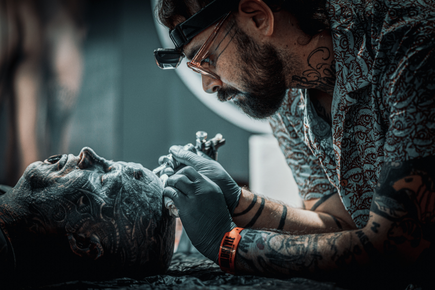 'Tattoo'. This was a very interesting scene between two artists, which I photographed at a tattoo fair in Austria in spring 2022. The halo behind the tattooist makes the scene more attractive. © Markus Pasa, Austria, Shortlist, Open Competition, Lifestyle, 2023 Sony World Photography Awards