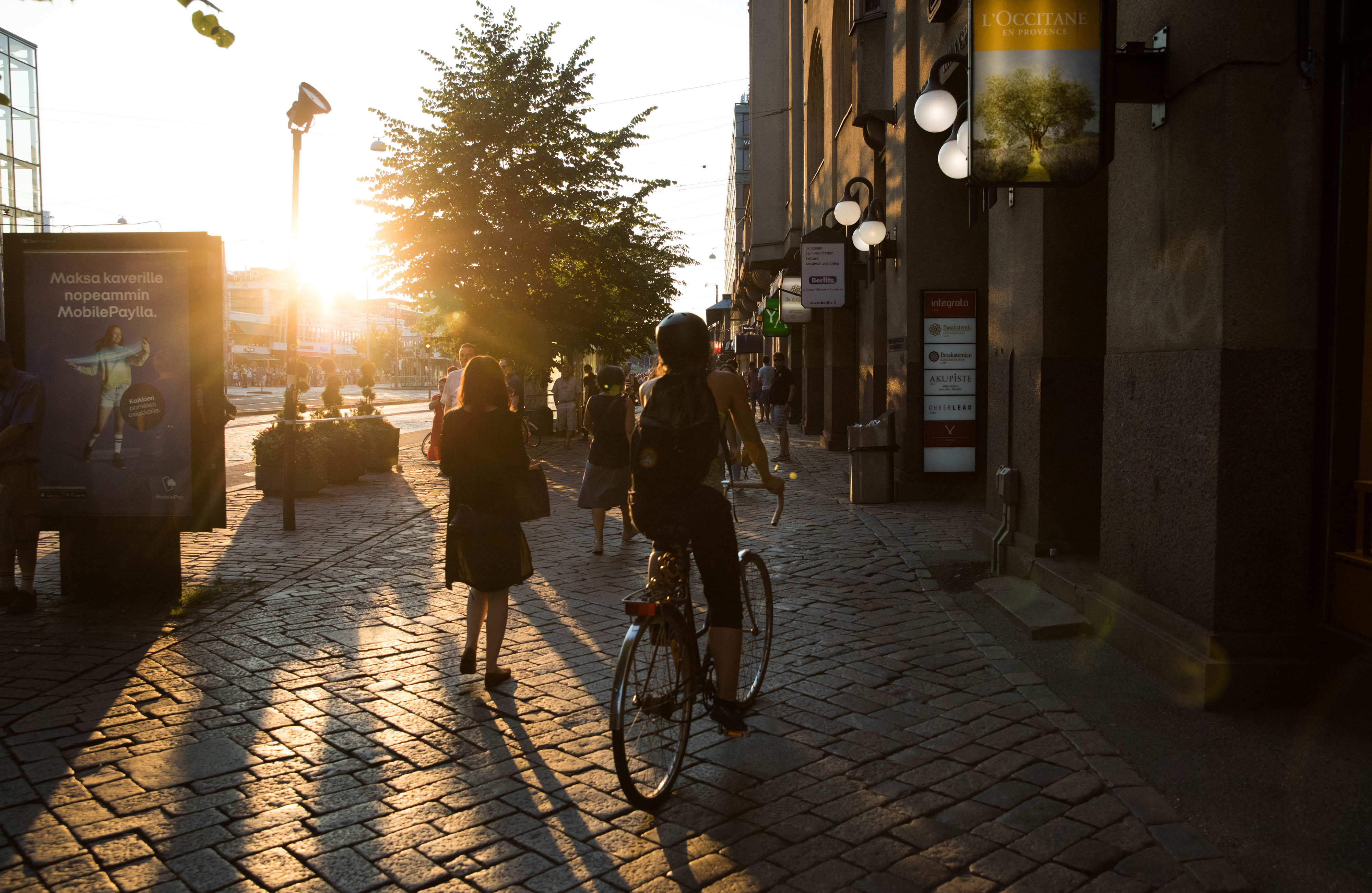 A cyclist rides down a street as the sun sets in Helsinki, Finland, on Monday, July 16, 2018. Photographer: Chris Ratcliffe/Bloomberg via Getty Images