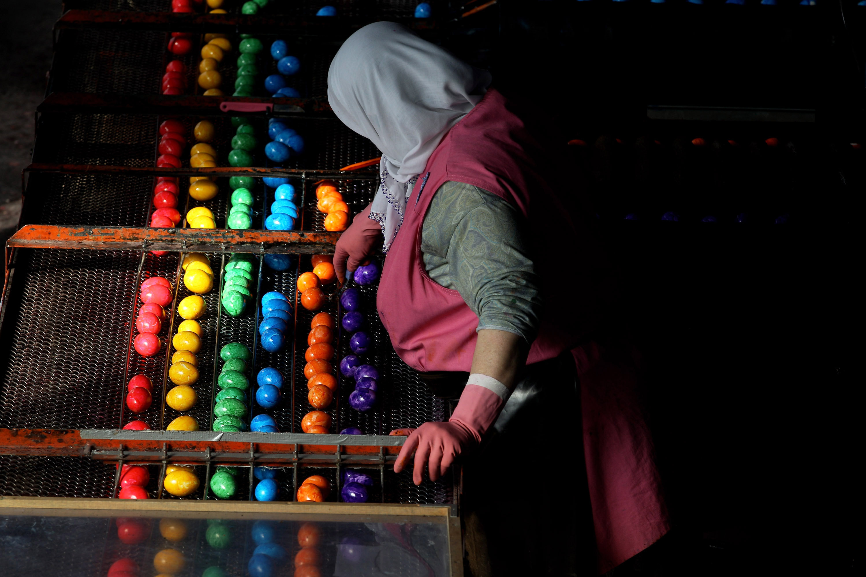 A worker oversees cooked, coloured eggs between production stages at the Beham coloured eggs company on March 30, 2010 in Thannhausen, Germany. Beham is Bavaria�s biggest coloured eggs producer and has stepped up production to meet high demand ahead of Easter. (Photo by Miguel Villagran/Getty Images)