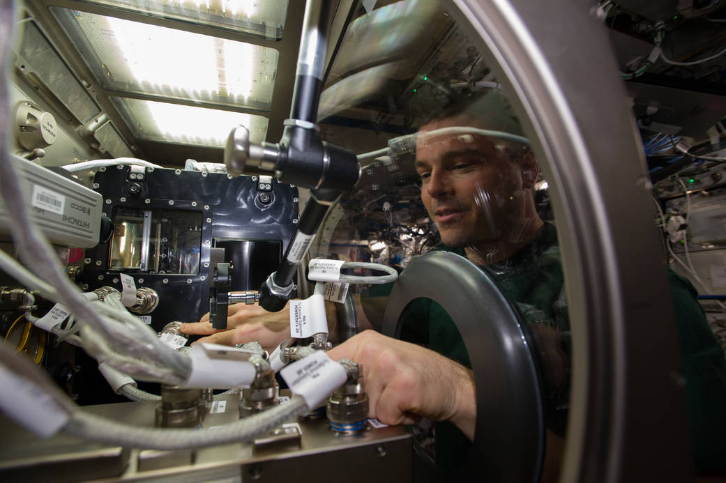 NASA astronaut Reid Wiseman, Expedition 40 flight engineer, installs Capillary Channel Flow (CCF) experiment hardware in the Microgravity Science Glovebox (MSG) located in the Destiny laboratory of the International Space Station. CCF is a versatile experiment for studying a critical variety of inertial-capillary dominated flows key to spacecraft systems that cannot be studied on the ground. Image: NASA