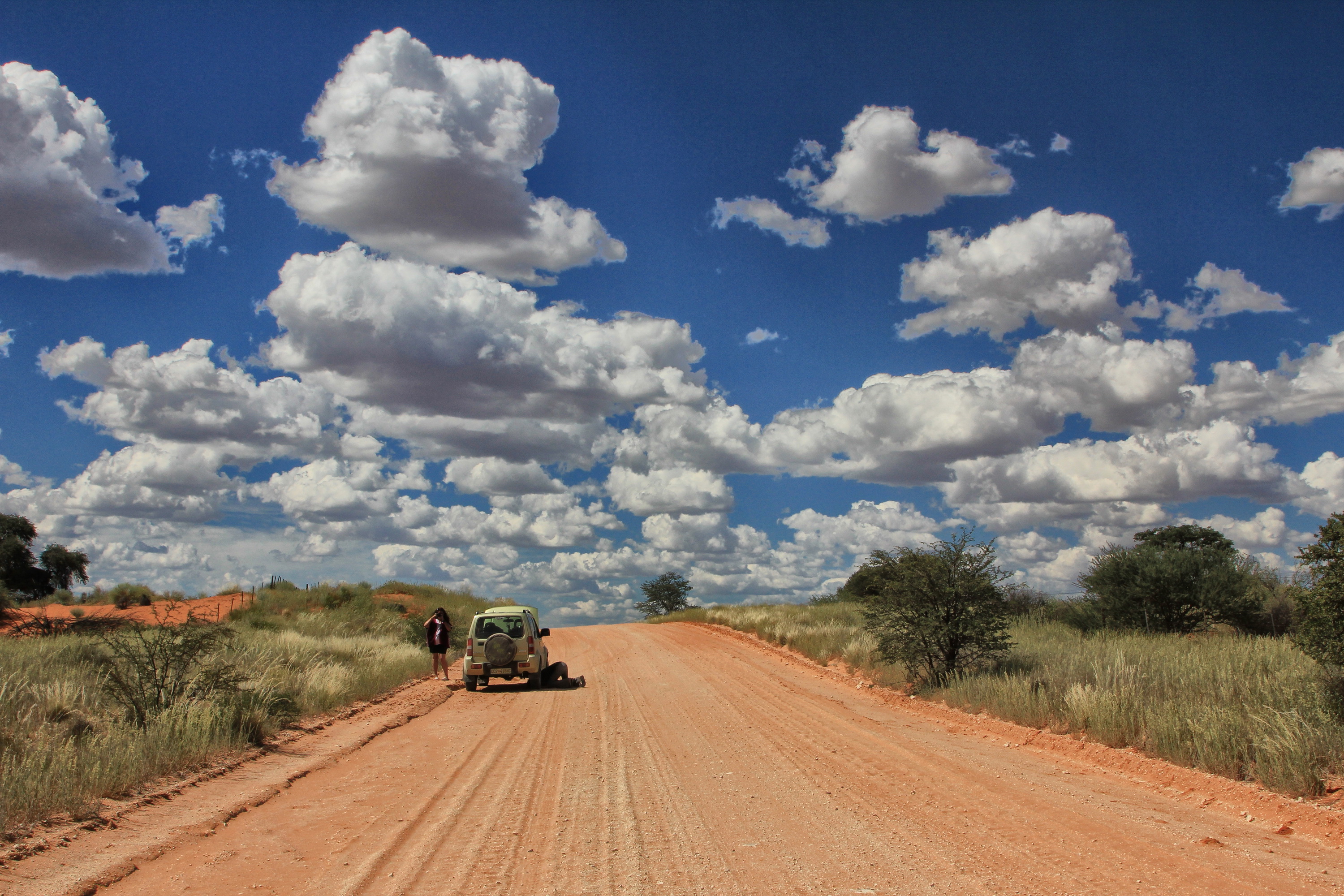 Overlanders in the Kalahari checking the undercarriage of their Jimny. Image: Chris Marais