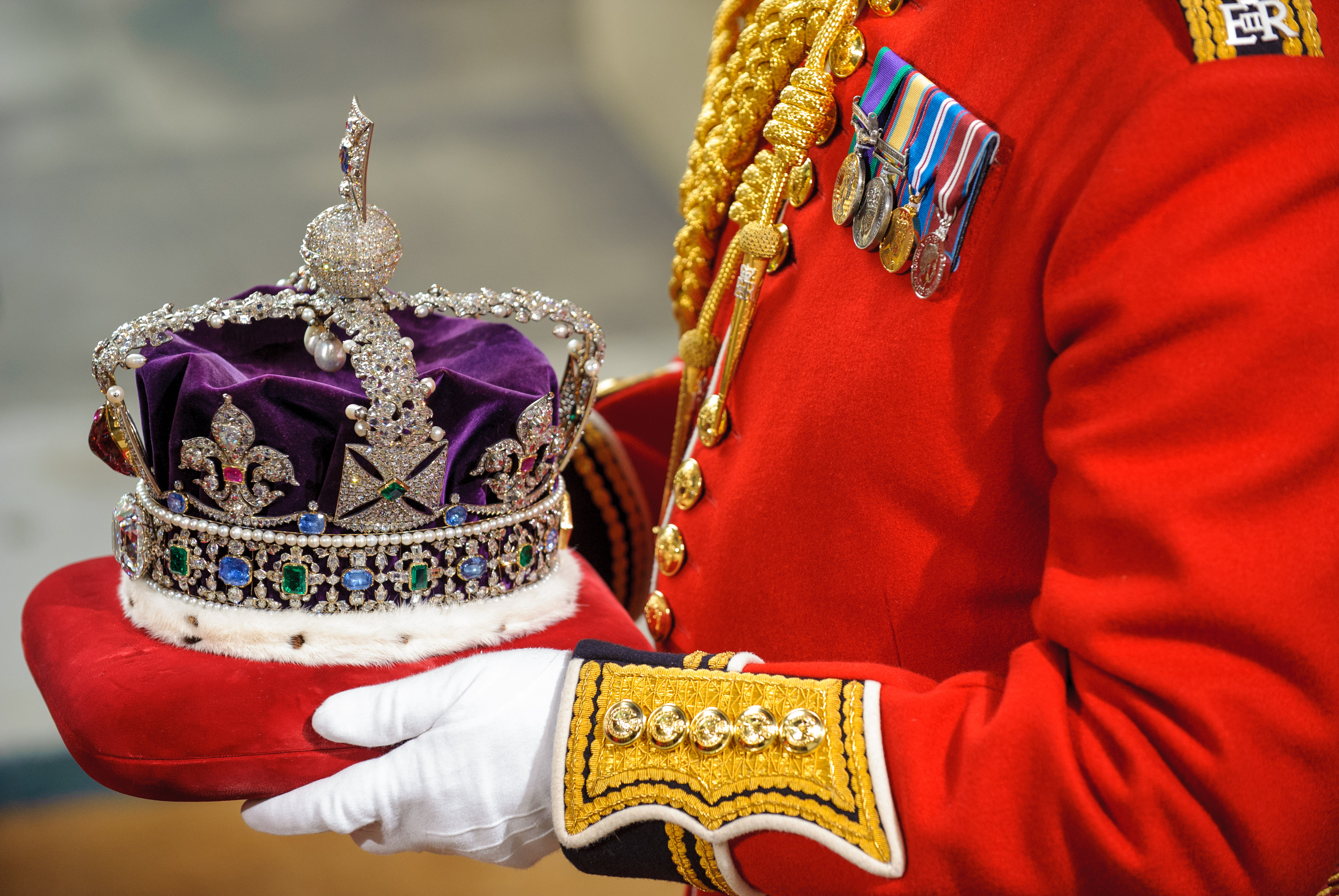 LONDON, ENGLAND - MAY 09: The Imperial State Crown is carried through the Norman Porch of the Palace of Westminster during the State Opening of Parliament on May 09, 2012 in London, England. Despite opposition from Conservative MPS, the Queen is expected to use her speech to push forward reforms in the House of Lords. Plans to split up banks and change rules on executive pay are also due to be addressed by the government. (Photo by Suzanne Plunkett - WPA Pool/Getty Images)