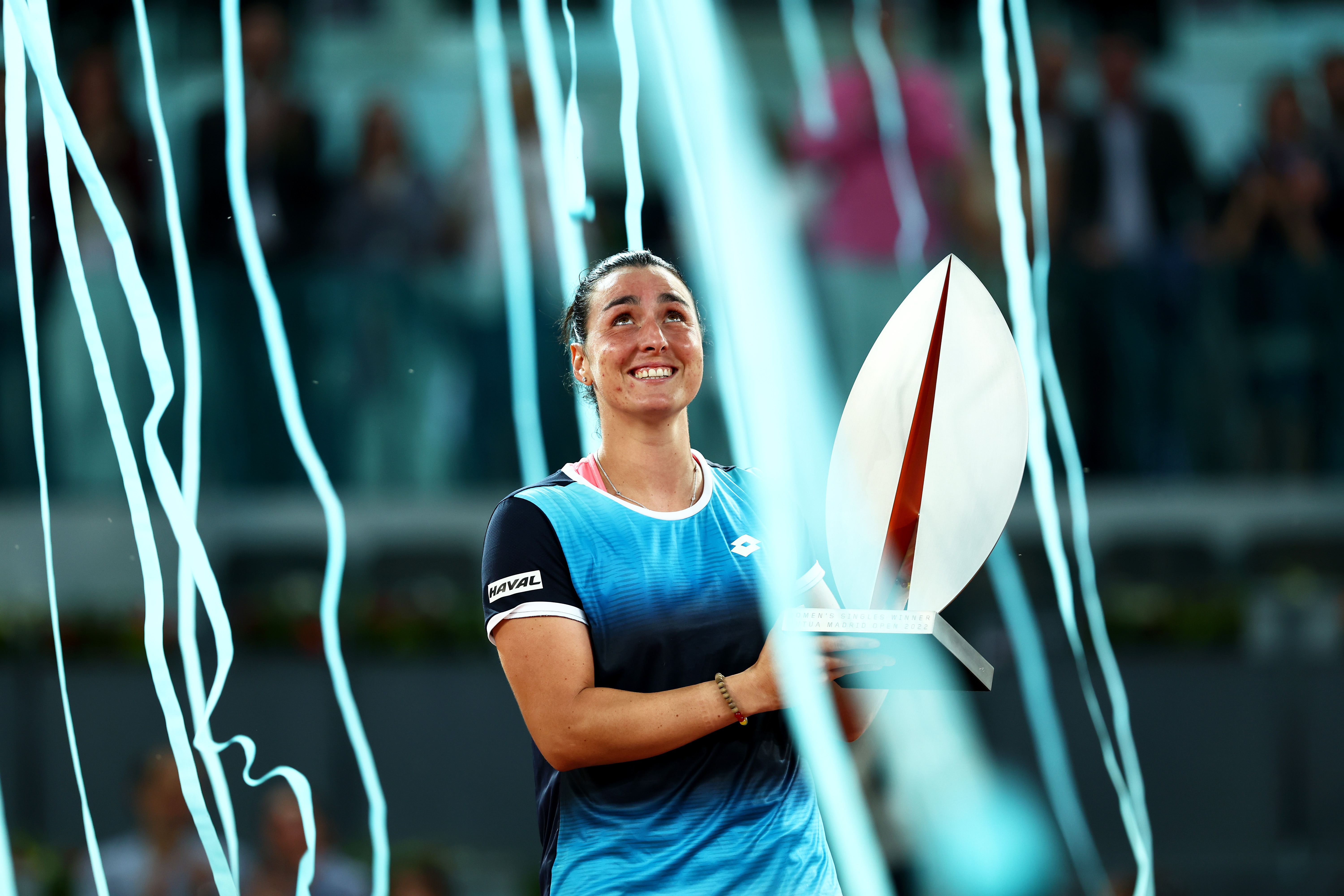 MADRID, SPAIN - MAY 07: Ons Jabeur of Tunisia celebrates with the trophy following victory during the Women's Singles final match against Jessica Pegula of the United States during day ten of Mutua Madrid Open at La Caja Magica on May 07, 2022 in Madrid, Spain. (Photo by Clive Brunskill/Getty Images)