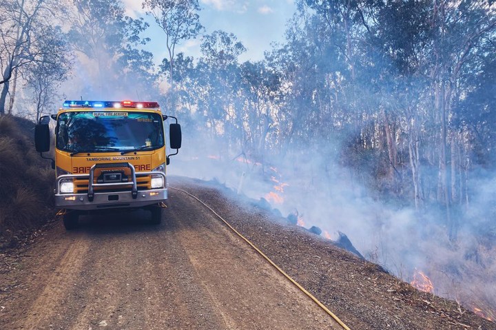 Two dead, dozens of homes destroyed as bushfires rage across eastern Australia