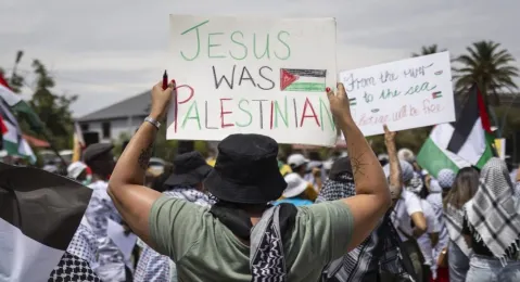 A protester holding up a sign as part of the International Day of Solidarity with the Palestinian People protest, Johannesburg, South Africa, 29 November 2023. Various political parties including the ruling ANC (African National Congress) and opposition EFF (Economic Freedom Fighters) as well as pro Palestine groups took part in the protest. The National Assembly has voted in favour of a motion by the EFF for the South African government to sever diplomatic ties with Israel and close the Israeli embassy in Pretoria due to the ongoing conflict in Gaza.  EPA-EFE/KIM LUDBROOK