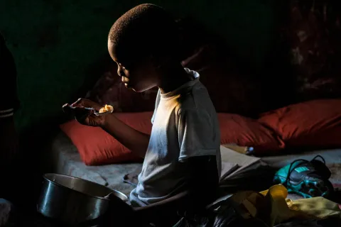Many people in the Eastern cape are living in poverty.  A 10 Year old boy eating  food. (Photo: Hoseya Jubase)
