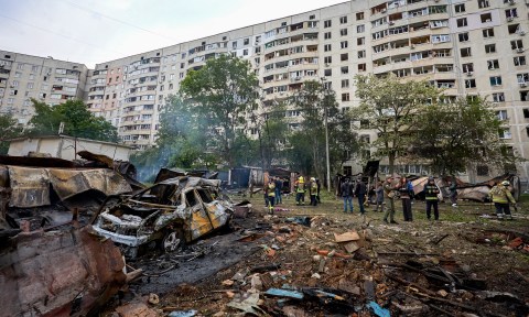 Ukrainian rescuers work at the site of a shelling of a residential area in Kharkiv on Tuesday. At least 21 people were wounded, including three children, in the rocket and glide bomb attack. (Photo: Sergey Kozlov/EPA-EFE)