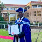 Former car guard shines beacon for plight of refugees in SA through PhD graduation