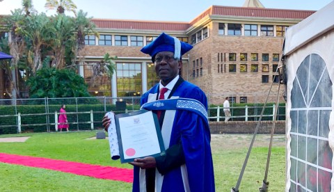 Former car guard shines beacon for plight of refugees in SA through PhD graduation
