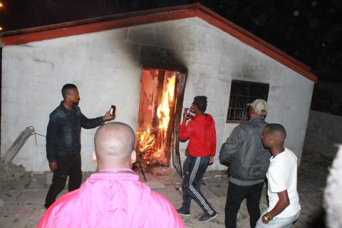 Khayelitsha residents torch house and dig ‘grave’ for man accused of killing Uyinene Mrwetyana