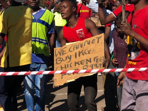 Informal settlement residents march to demand that stores lower food prices