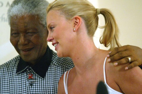 Theron kisses the girls for Mandela. Not!